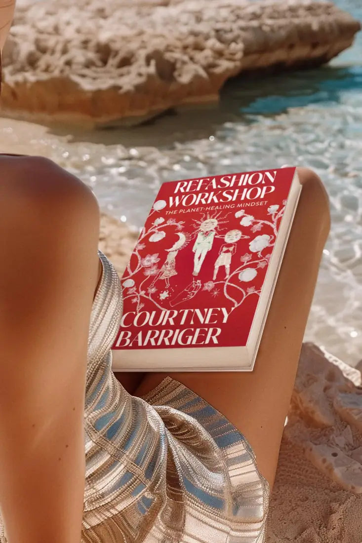 ReFashion Workshop book resting on a lap at the beach