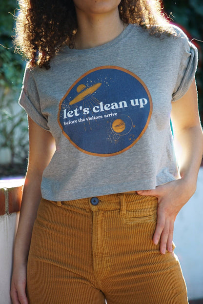 Badge Crop TopHolding Court IncLet’s clean up… before the visitors arrive.
This statement piece is crafted from 100% Organic Cotton, harvested and made in Tanzania with fair and ethical wages. EnjT-shirtLet's Clean Up Badge Crop TopHolding Court INCHolding Court INCHolding Court INC