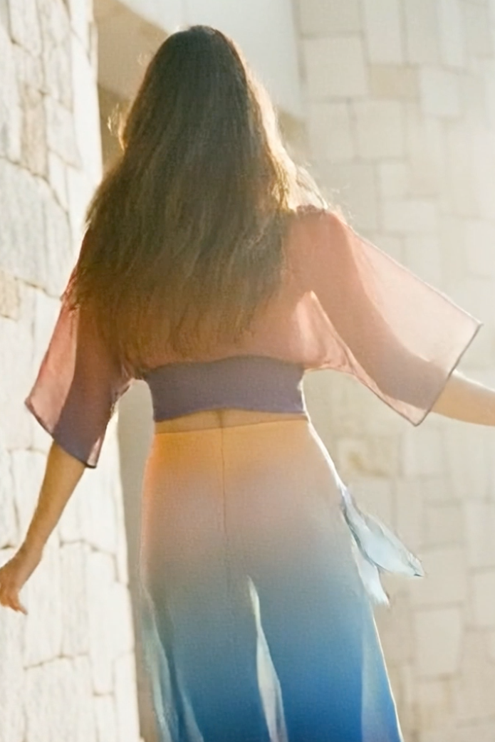 Woman in a flowing dress with a blurred background