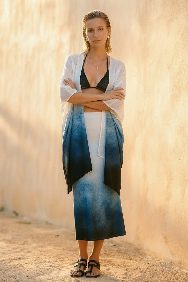 Woman wearing a blue and white dress with a beige wall background