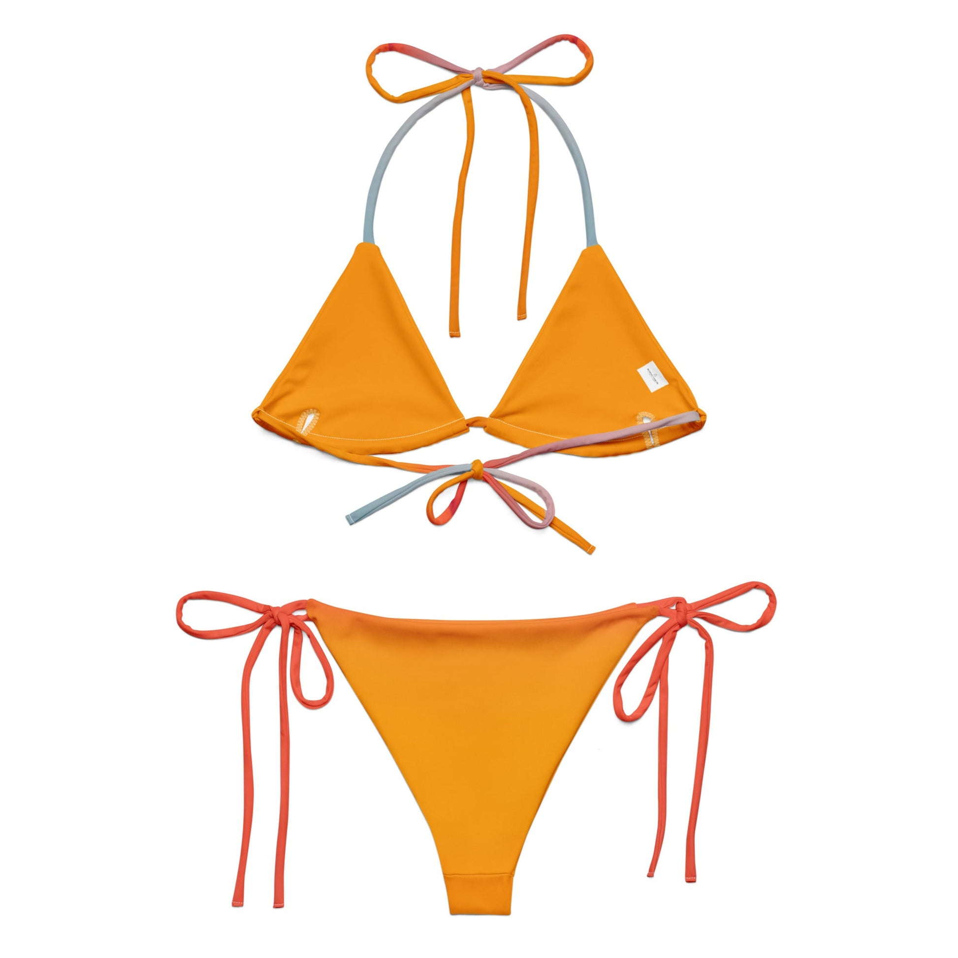 Editorial shot of the rainbow Vega String Bikini in Sunrise — Oeko-Tex certified recycled swimwear, non-toxic and skin-safe, from Holding Court Inc, made to order.