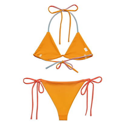 Editorial shot of the rainbow Vega String Bikini in Sunrise — Oeko-Tex certified recycled swimwear, non-toxic and skin-safe, from Holding Court Inc, made to order.